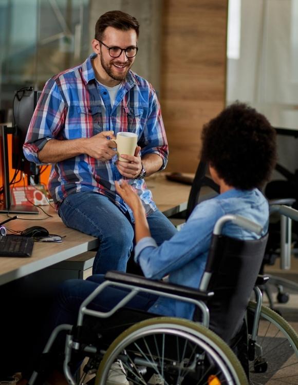 Two employees in office setting discussing non-clinical careers