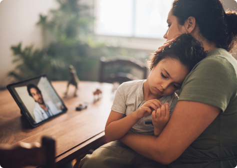 Mother and child using teleurgent care to speak with doctor using a tablet